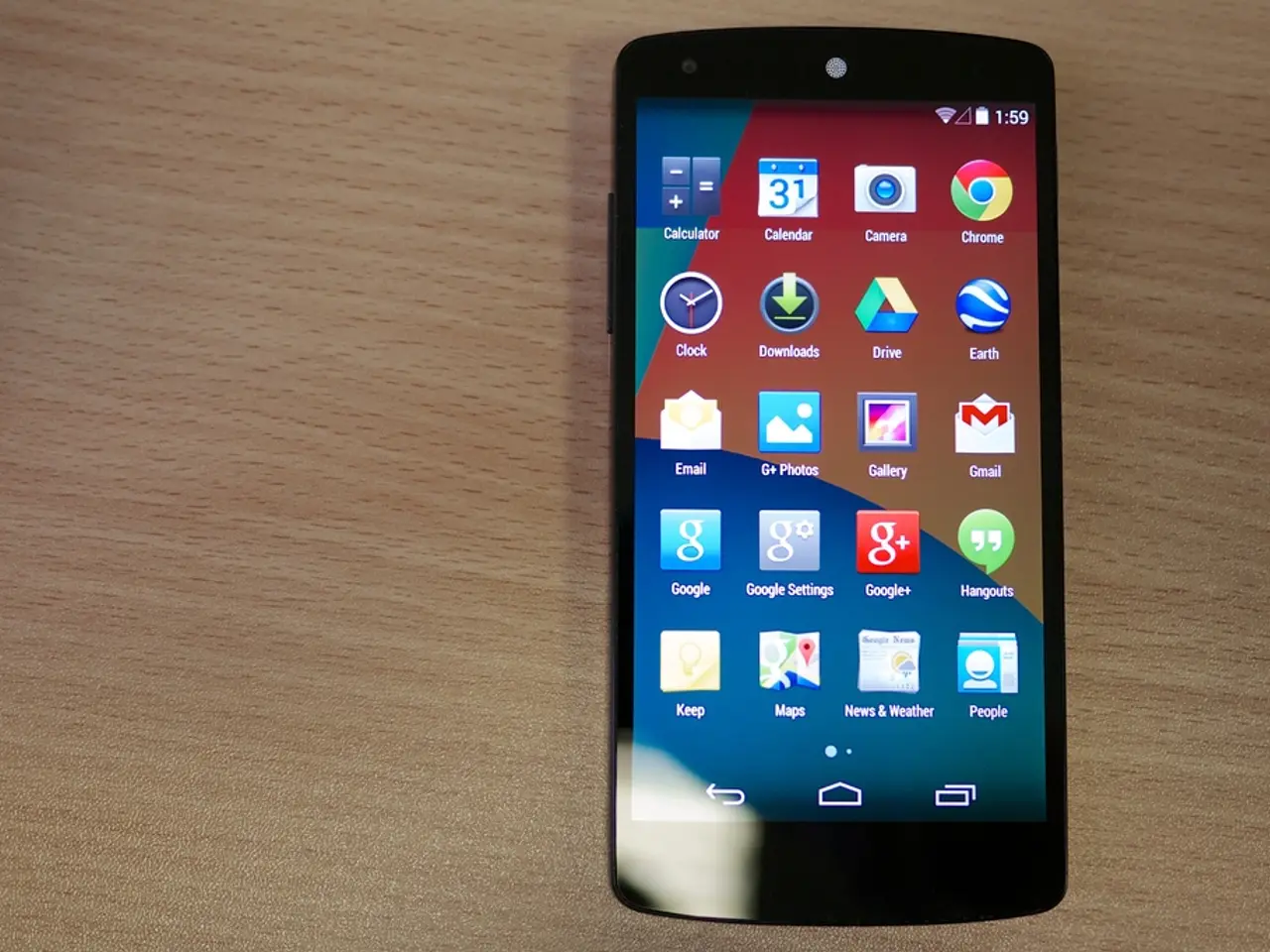In this image I can see a mobile is on the wooden surface. In the mobile there are applications.