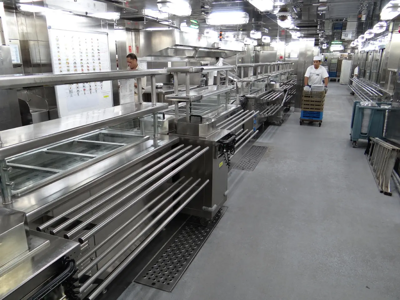 To the left side of the image there are machines. In the center of the image there is a person...