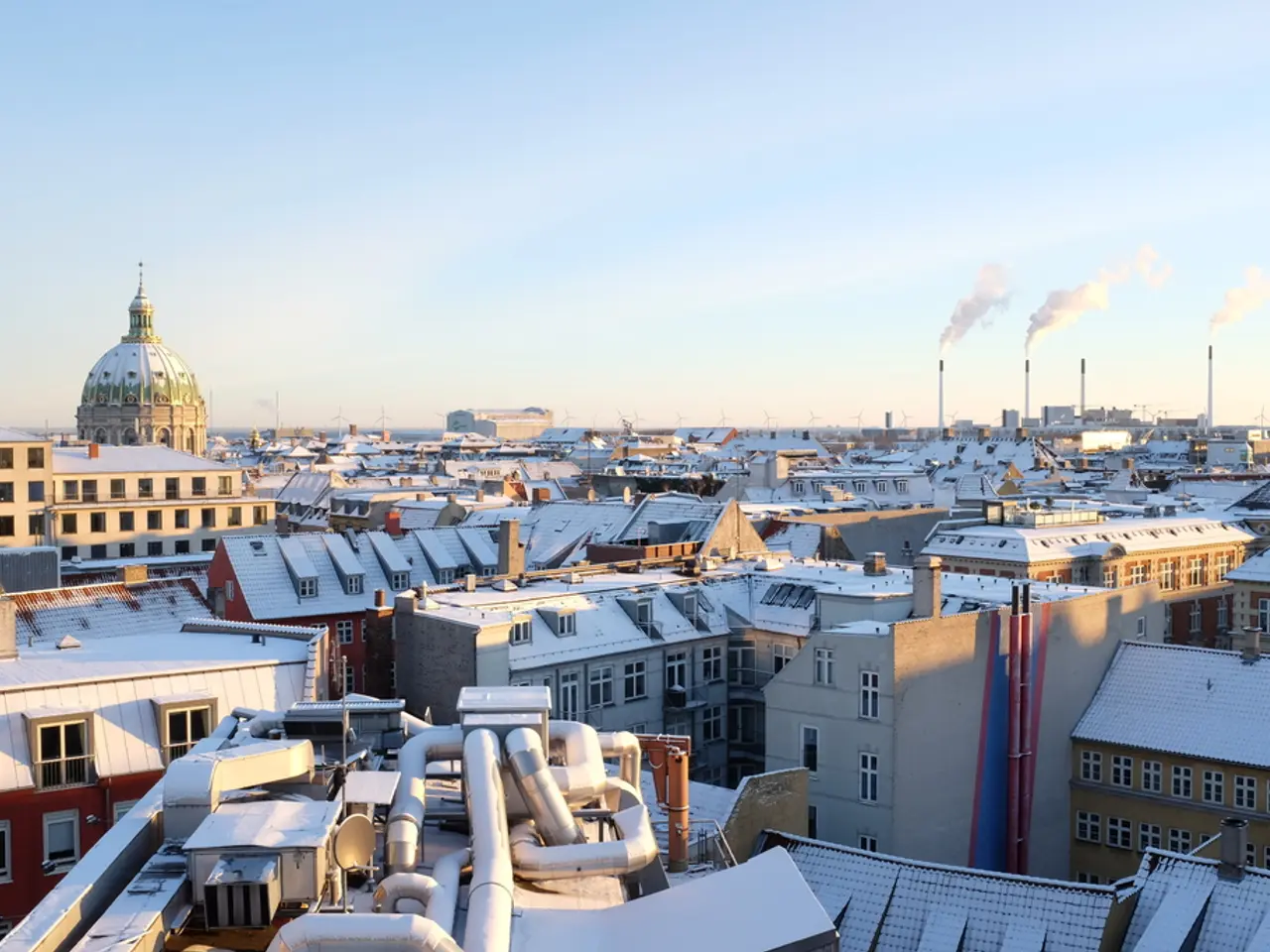 In this image I can see number of buildings and number of windows. Over there I can see smoke and...