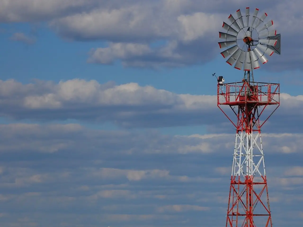 In this picture we can see a clear blue sky with clouds, trees and smoke. This is a Transmission...