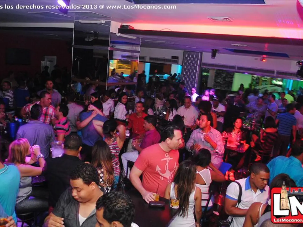 In this picture we can see some people are standing and some people are sitting, at the right...