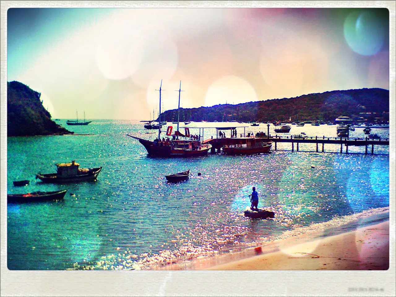 This a photograph and it is on an object. In the photograph we can see boats and ships on the water...