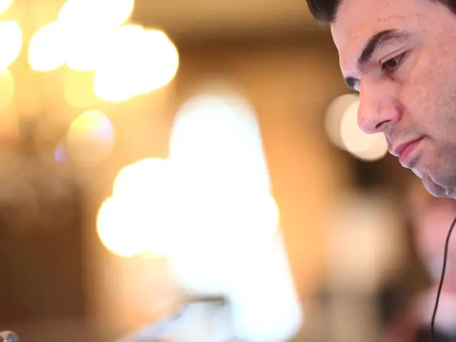 On the right side we can see a person wearing a headset. In the background it is blurred and there...