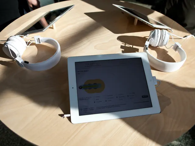 There is a table. There is a i pad and head phone on a table.