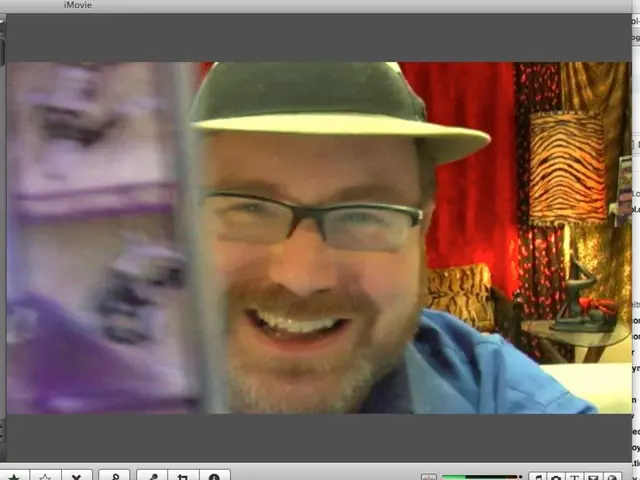 In this image I can see the monitor screen in which I can see a person wearing blue colored dress...