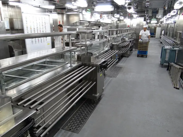 To the left side of the image there are machines. In the center of the image there is a person...