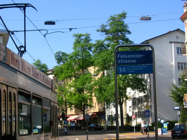 In this picture we can see a vehicle. On the right side of the image there is a car on the road. On...