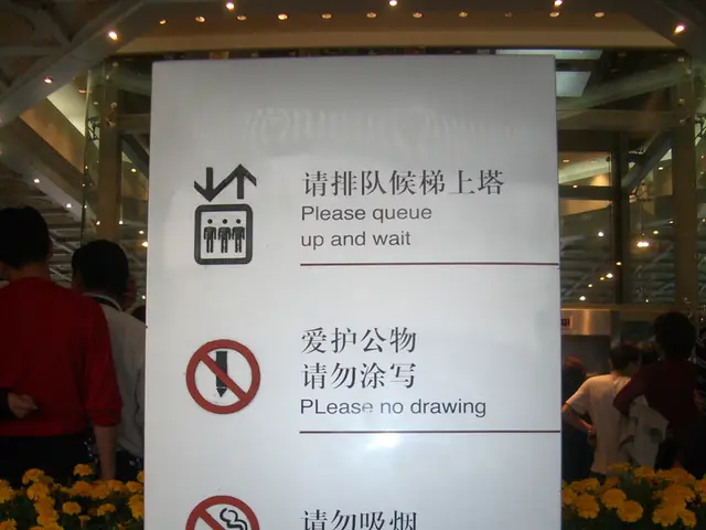 Here we can see board, behind this board we can see flowers, plants, people and lights.