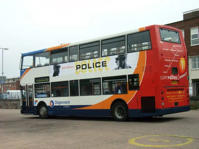 At the bottom of the image on the road there is a double decker bus with images and text. Behind...