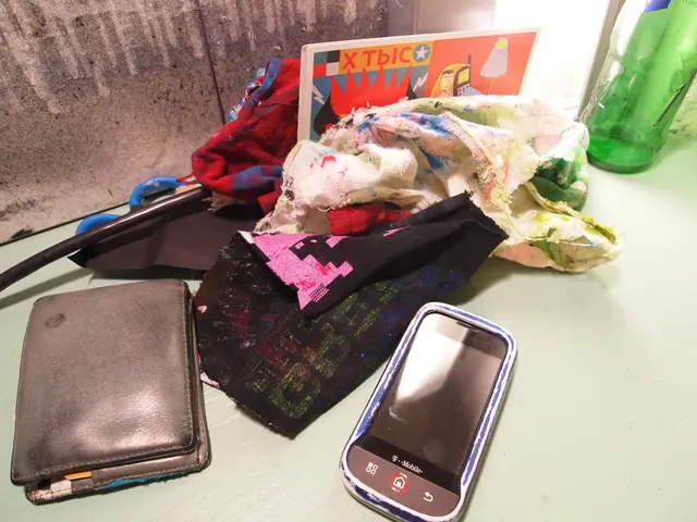In the image we can see there is are cloth pieces, a mobile phone and a wallet.