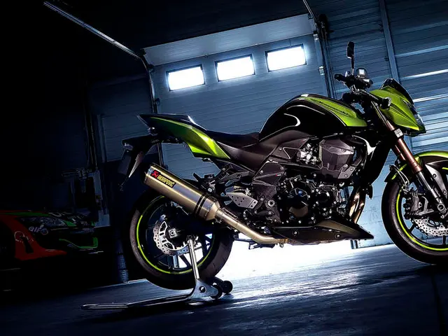 A green and black color vehicle is present in the middle of the image. There is a car on the left....